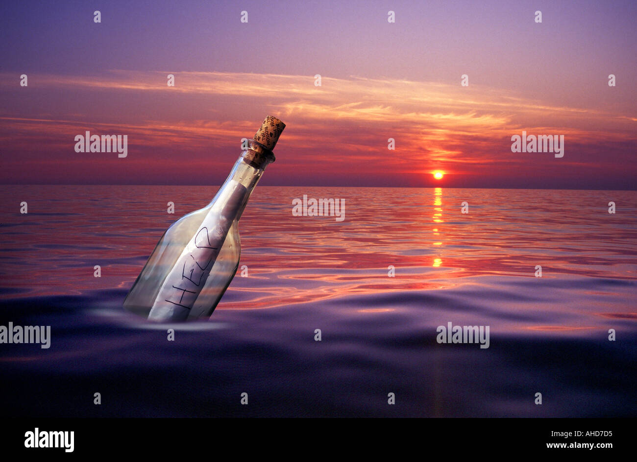 washed up on shore, message note, written on paper,  in a bottle floating on the sea at sunset sunrise Stock Photo