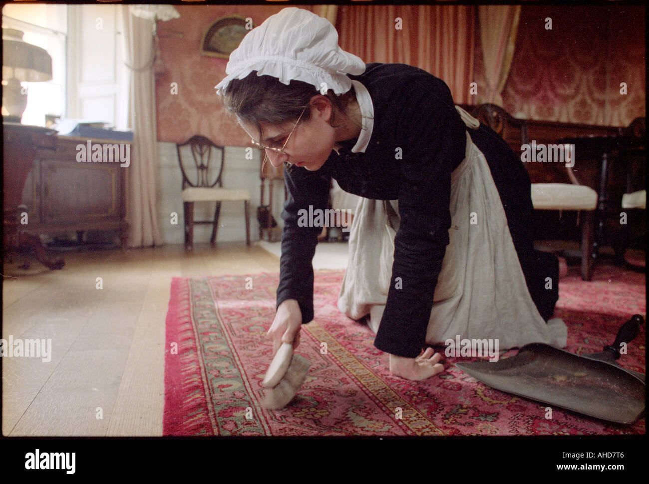 Housemaid Brushes Carpet Stock Photo