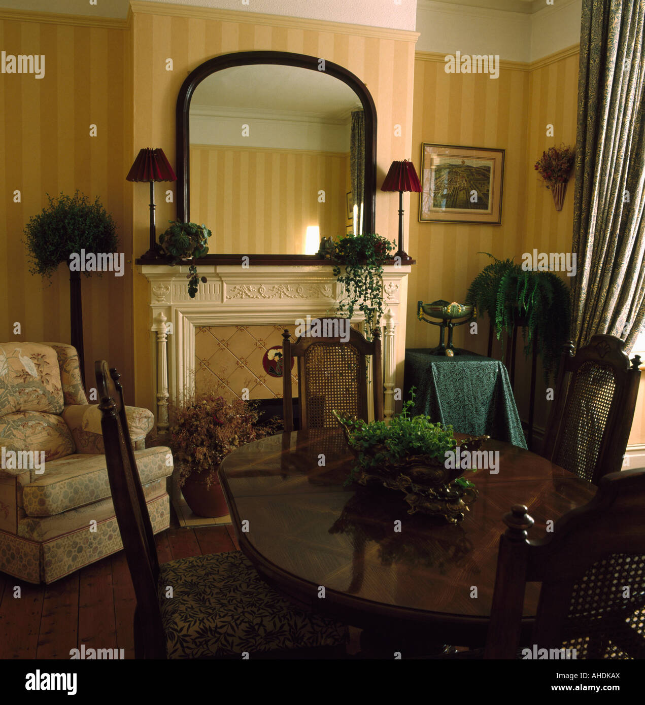 Mirror above fireplace in dining room with striped wallpaper Stock ...