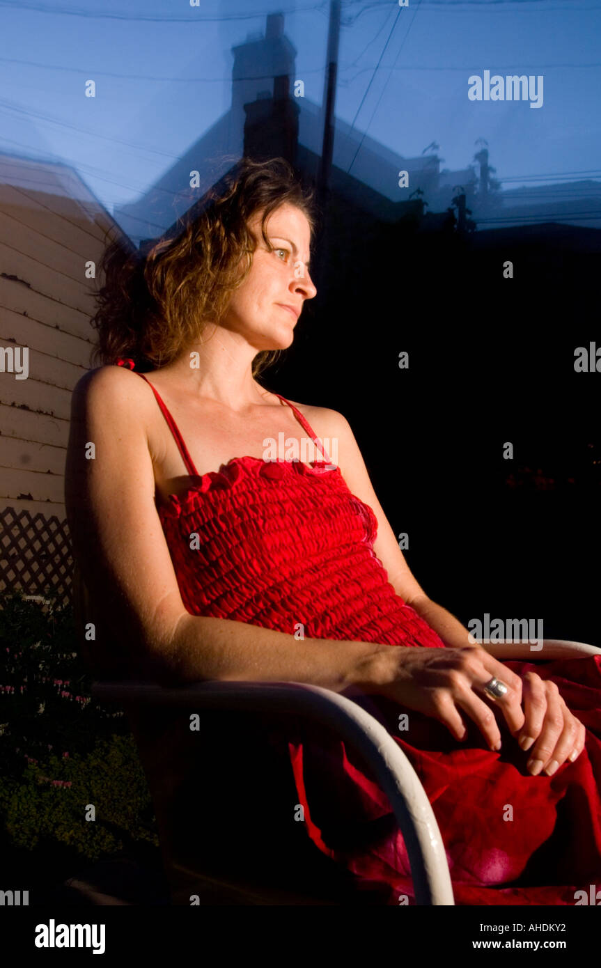 Woman red dress sitting hi-res stock photography and images - Alamy
