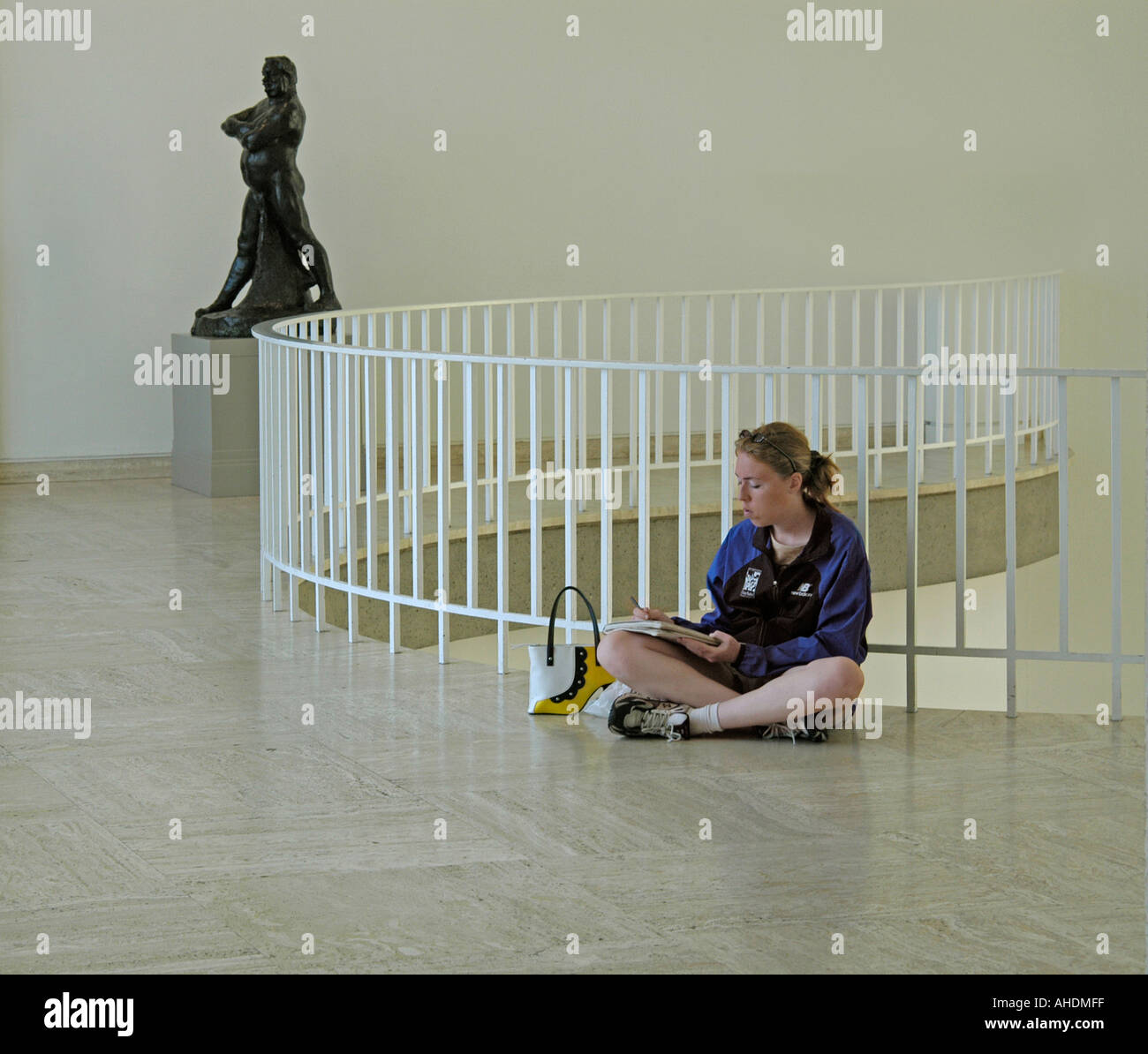 Yong woman sitting on the floor of Art museum and drawing, Milwaukee,Wisconsin,USA Stock Photo
