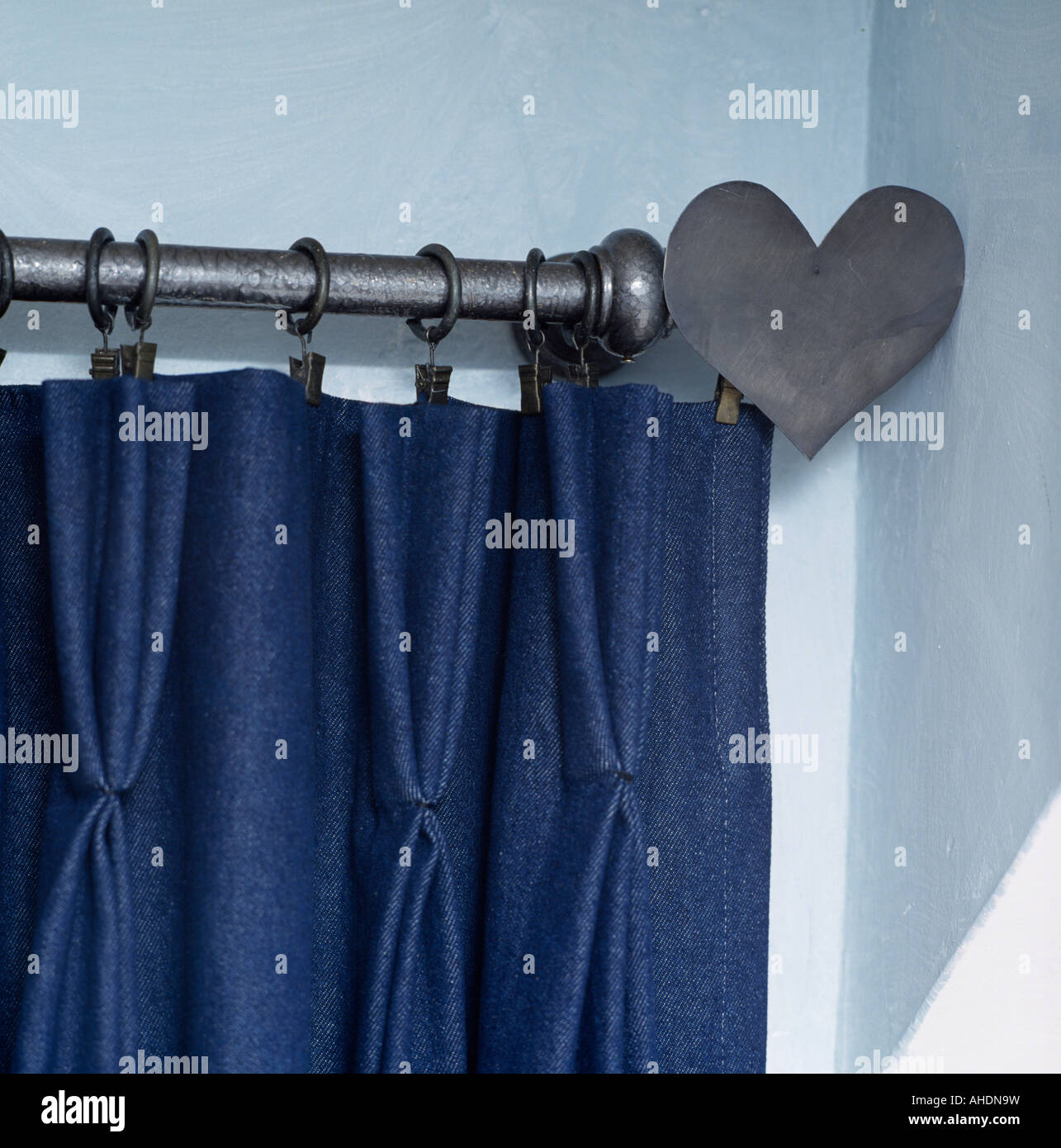 Close Up Of Pinch Pleated Dark Blue Curtain On Metal Curtain Pole
