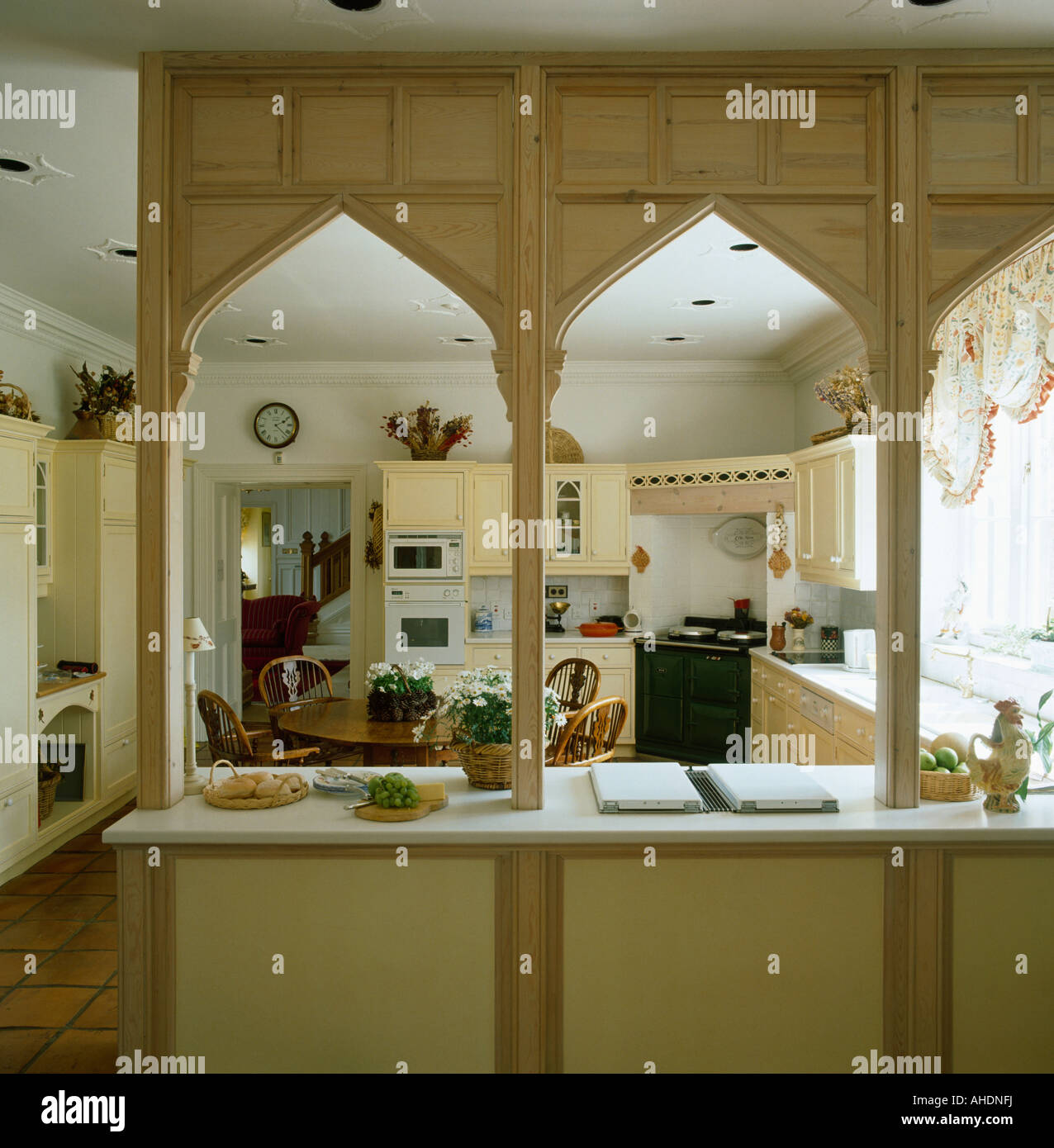 https://c8.alamy.com/comp/AHDNFJ/arched-wooden-gothic-style-divider-on-worktop-in-neutral-country-kitchen-AHDNFJ.jpg
