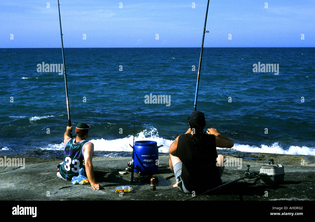 Ocean Angling Two men sea angling off rocks, Bridport, Tasmania, Australia Stock ...