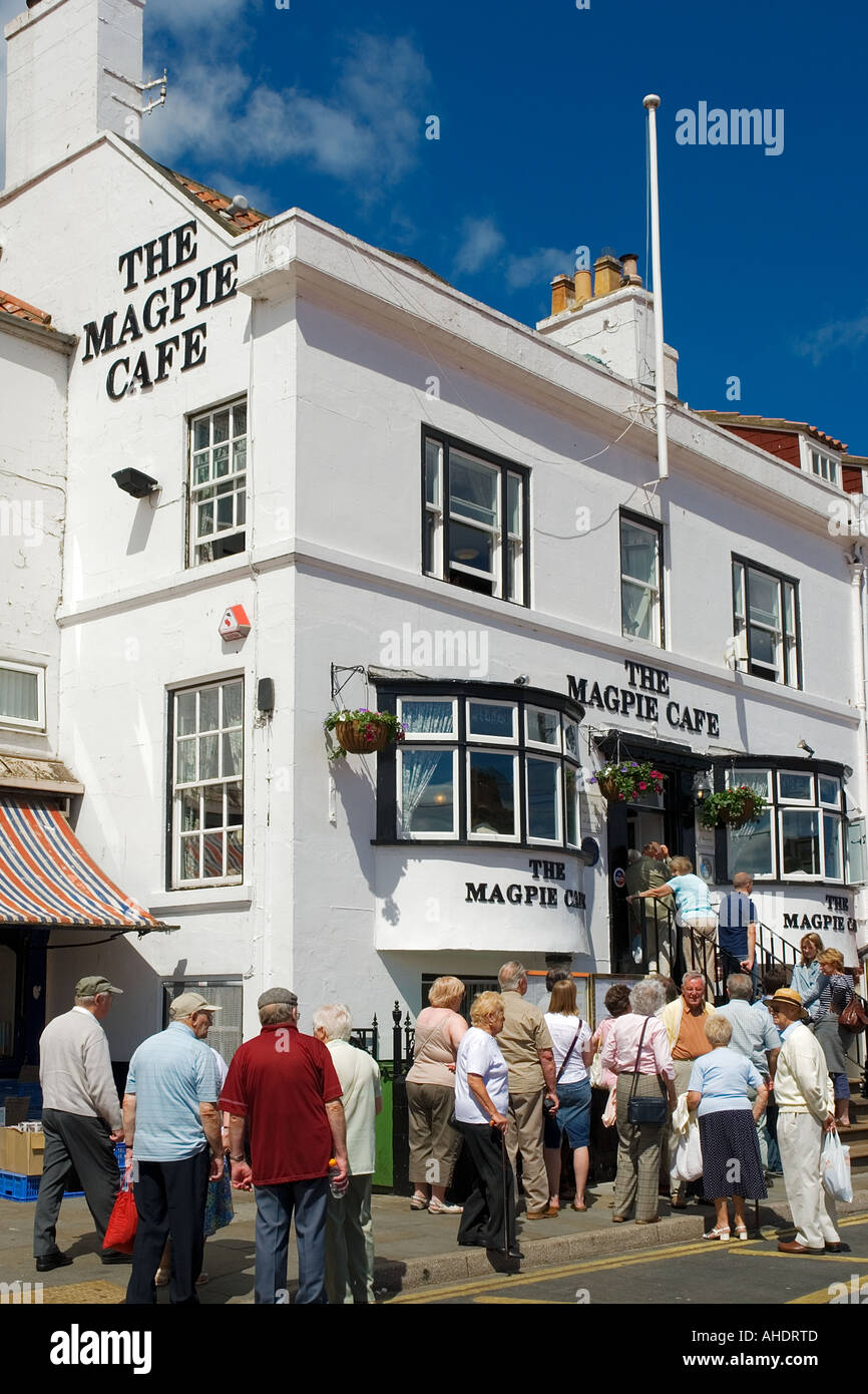 Queue of people wait for fish and chips outside the famous Magpie Cafe Whitby North Yorkshire England Stock Photo