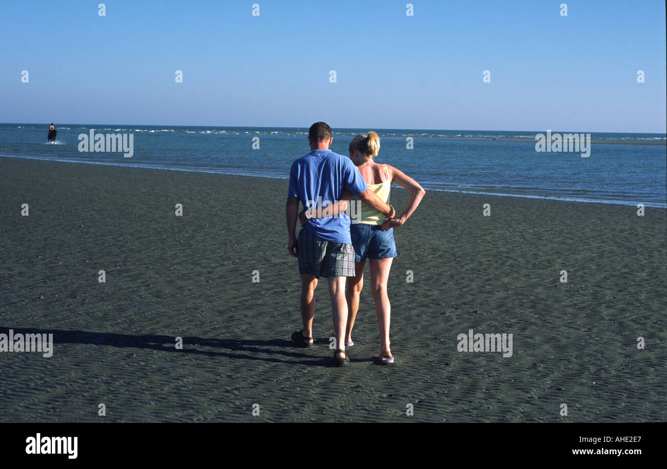 UK East Sussex West Witterings Beach Lovers Walking Together Stock Photo
