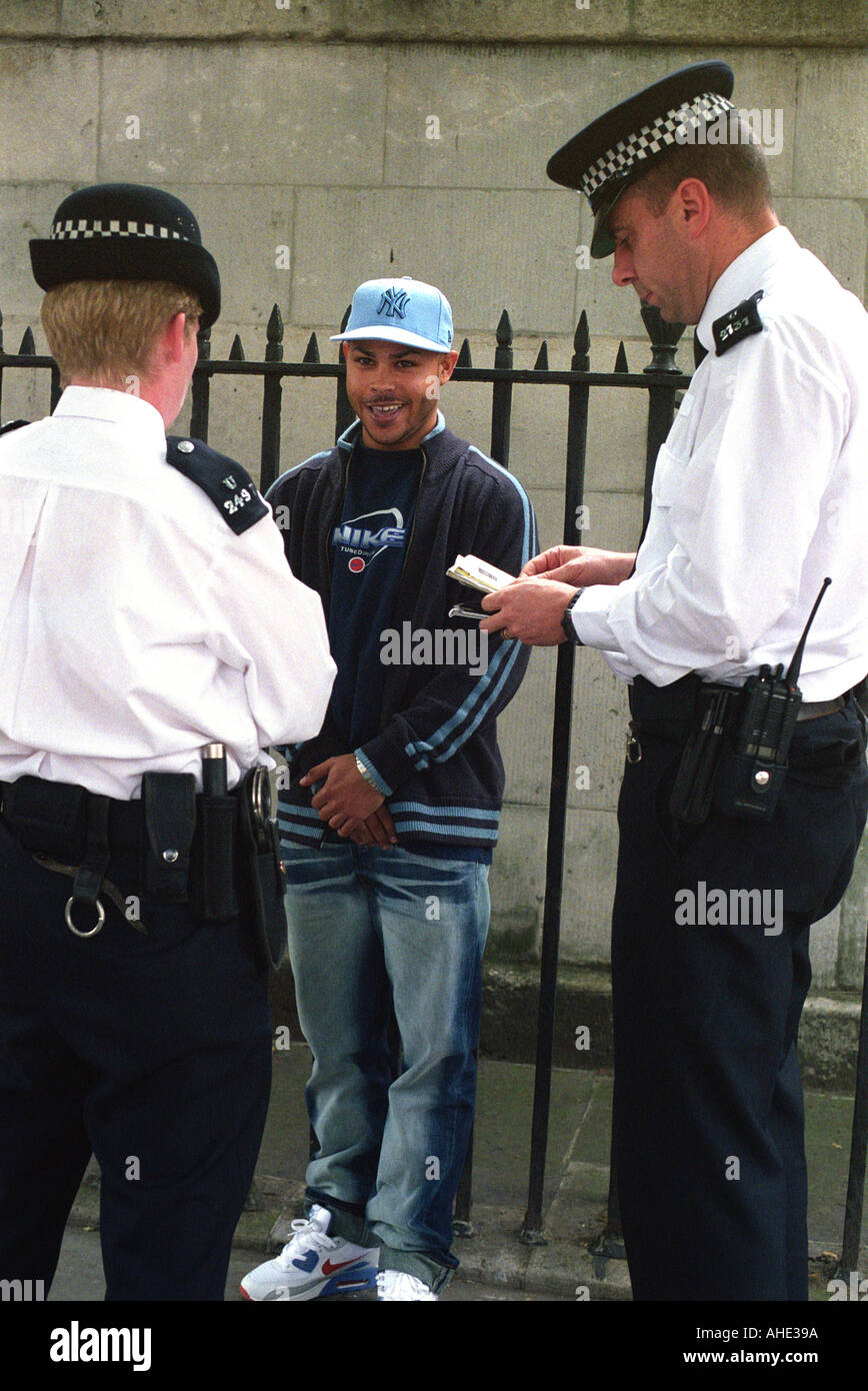 Youth being stopped and searched by police on Whitehall in central London. Stock Photo