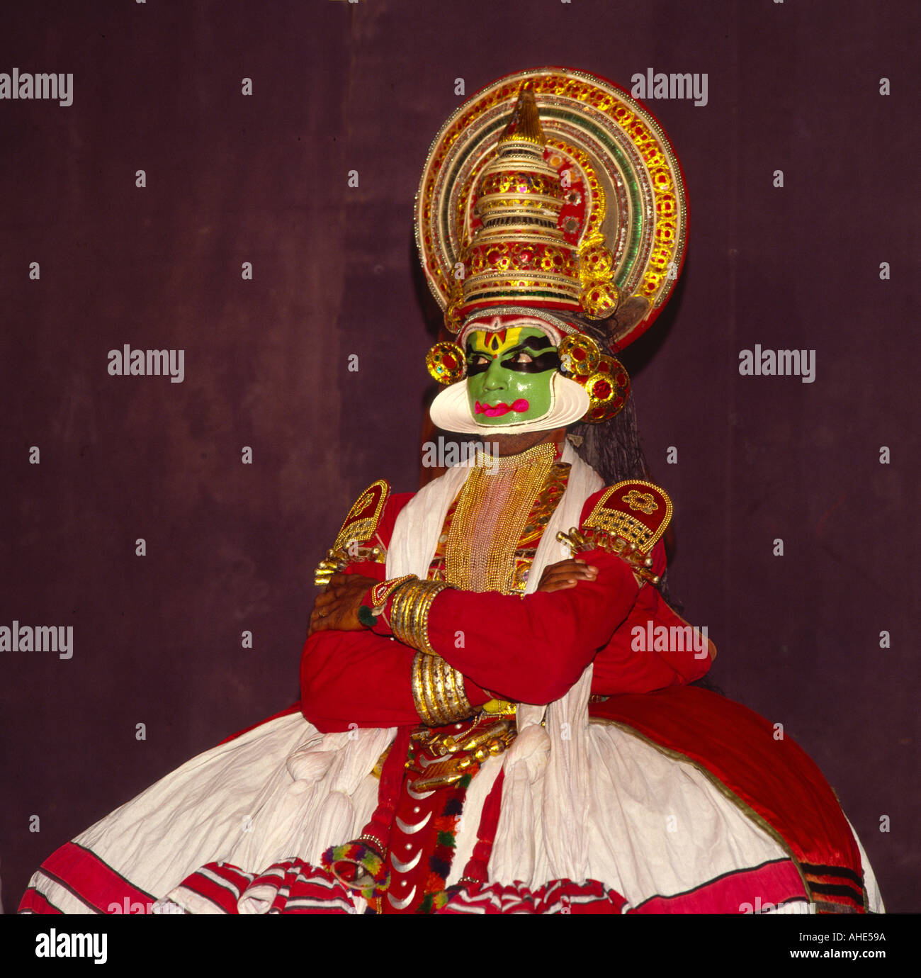 Traditional Kathakali dancer with complex green yellow and black facial and eye make-up performing in Cochin Kerala South India Stock Photo