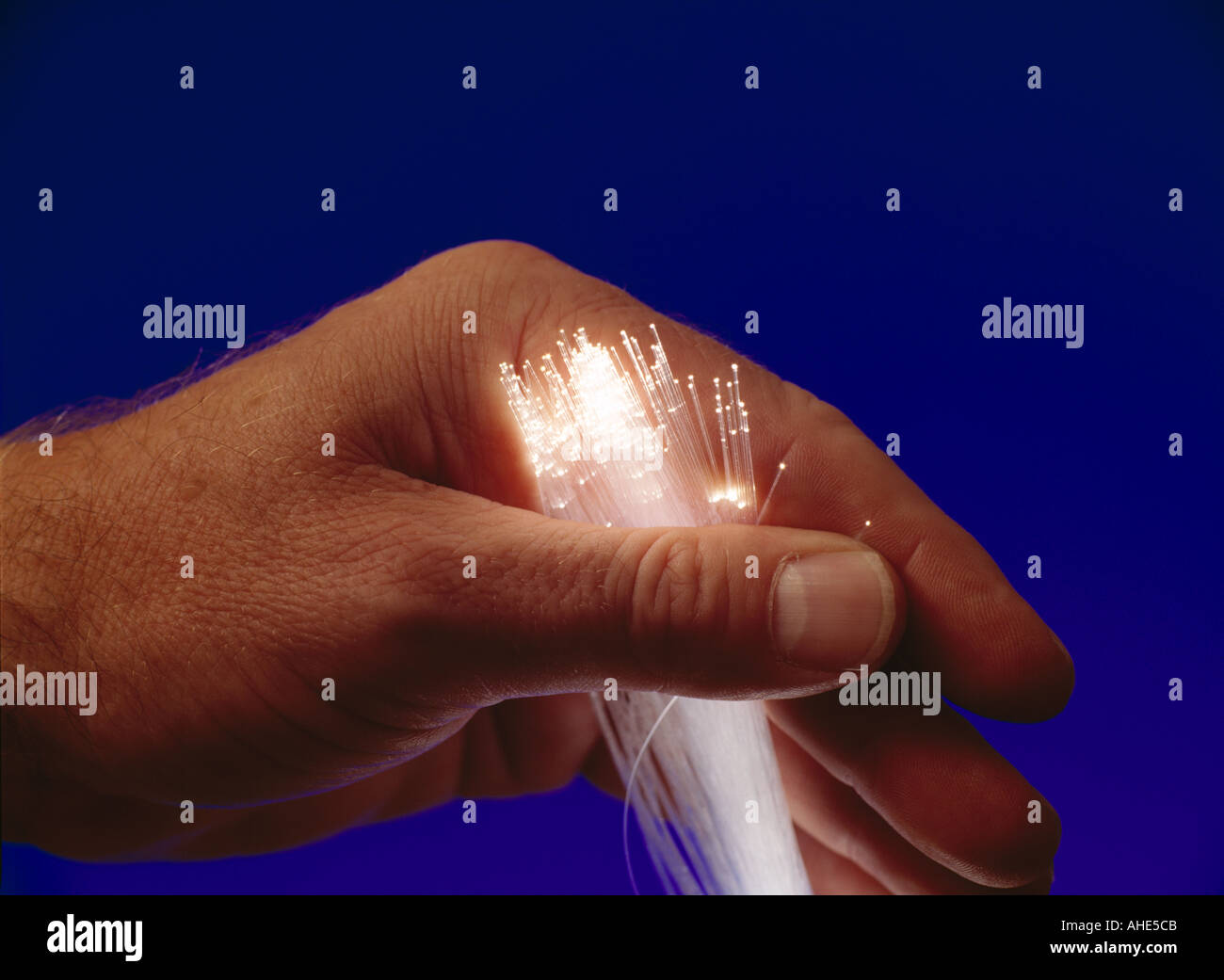 A hand playing with fibre optics Stock Photo