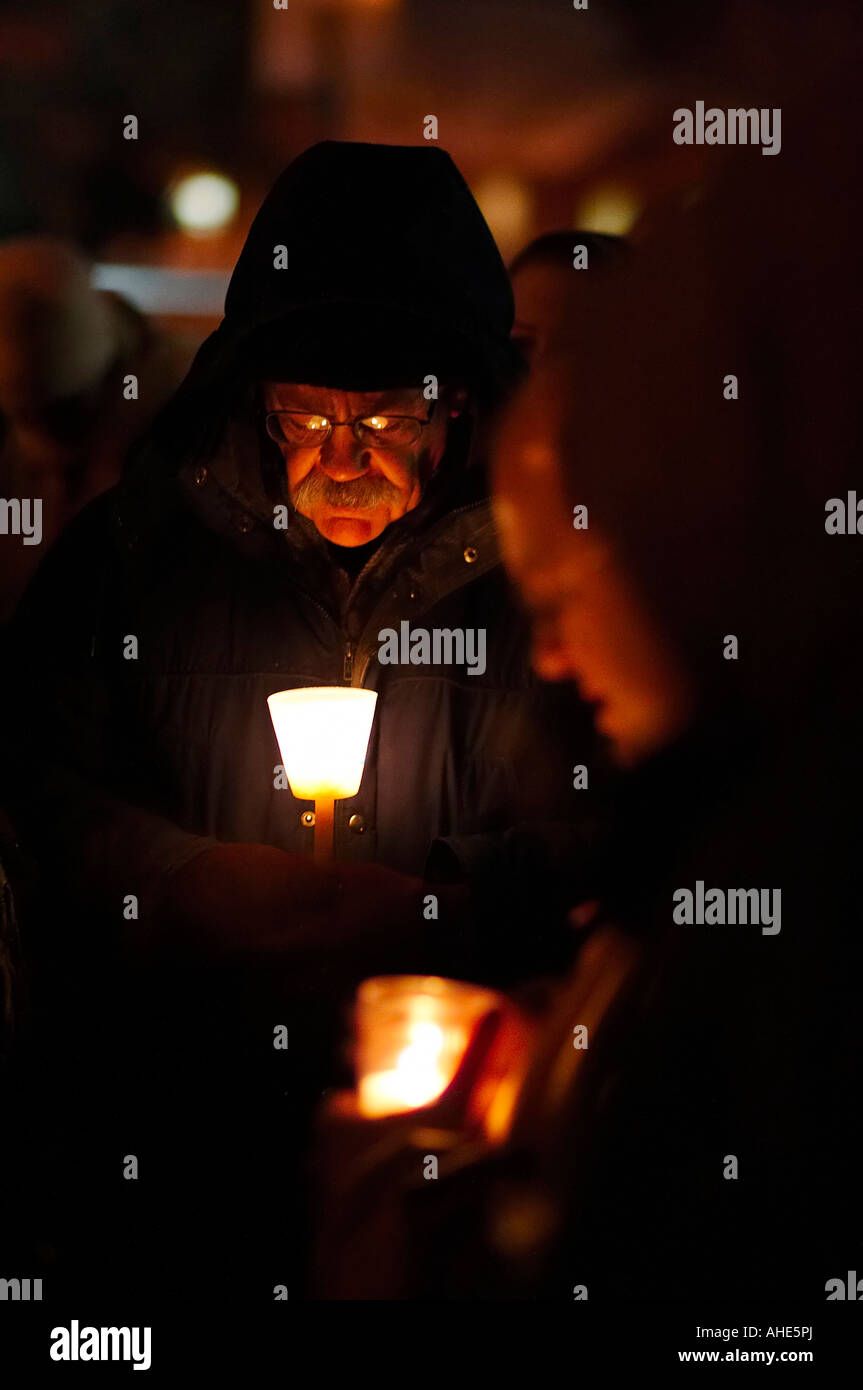 A man and other people holding candles during a candlelight vigil praying for an end to abortion Stock Photo