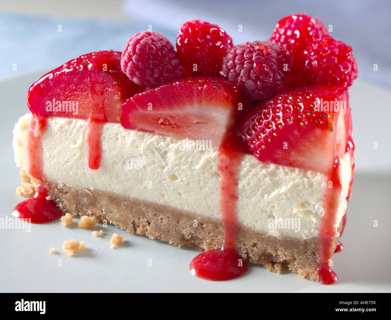 A slice of raspberry and strawberry cheesecake editorial food Stock