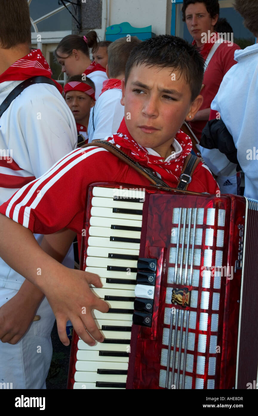 a young boy playing the piano accordion on obby oss day in padstow, cornwall, england Stock Photo