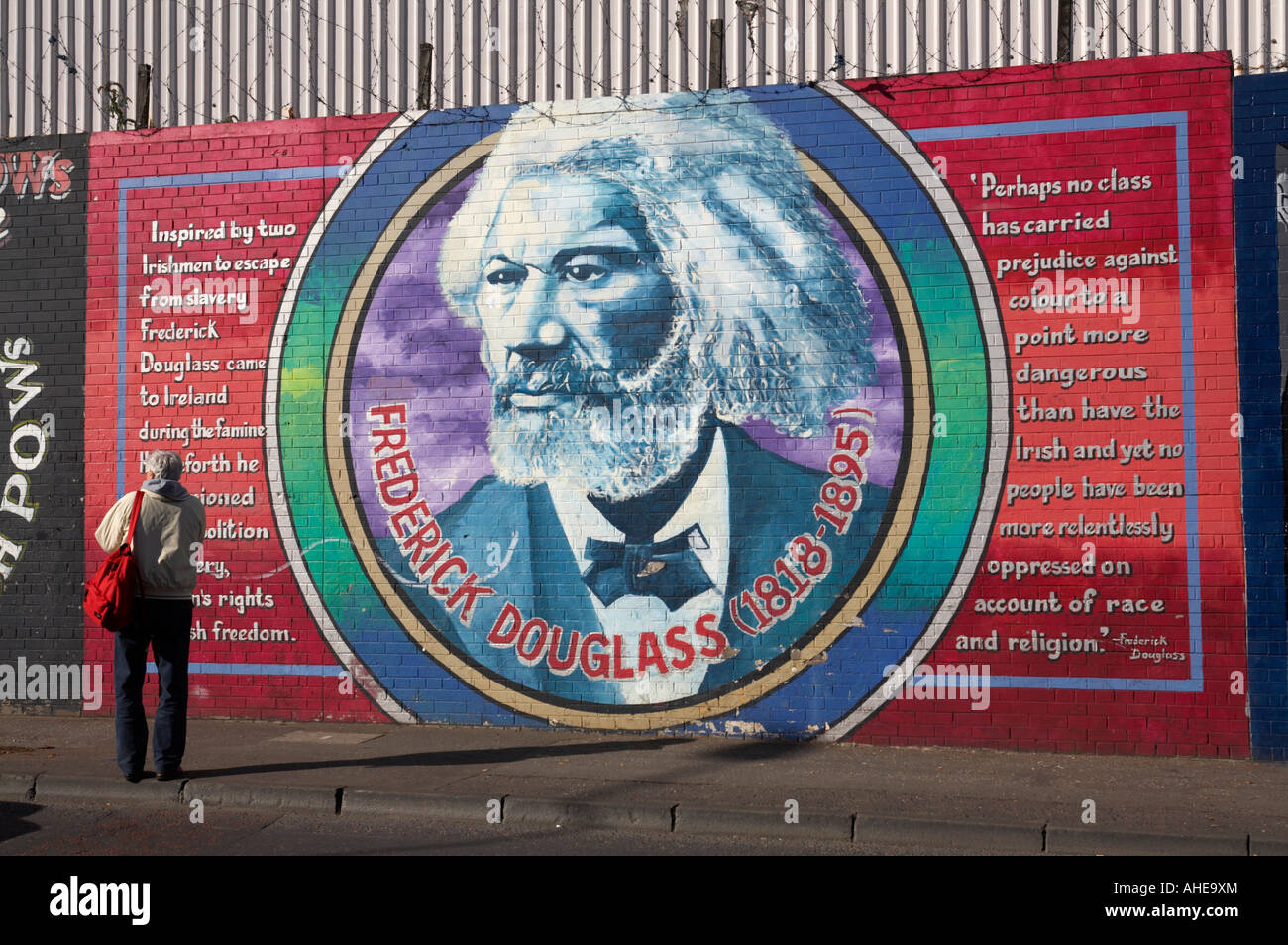 tourists browses International wall murals in the republican falls road area of west belfast