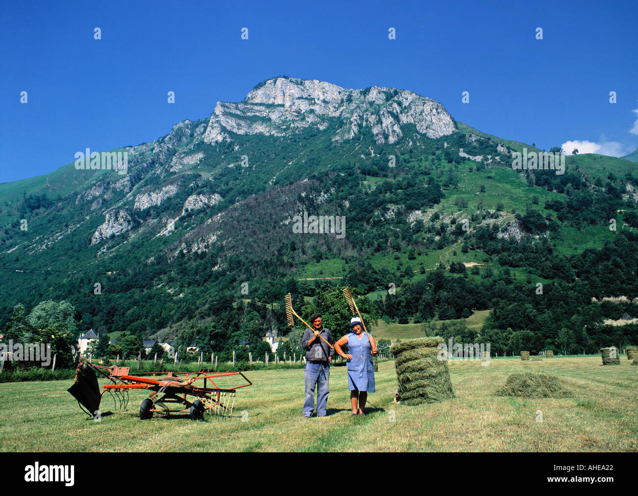 Farmers in field near Arudy, Pyrenees, France Stock Photo