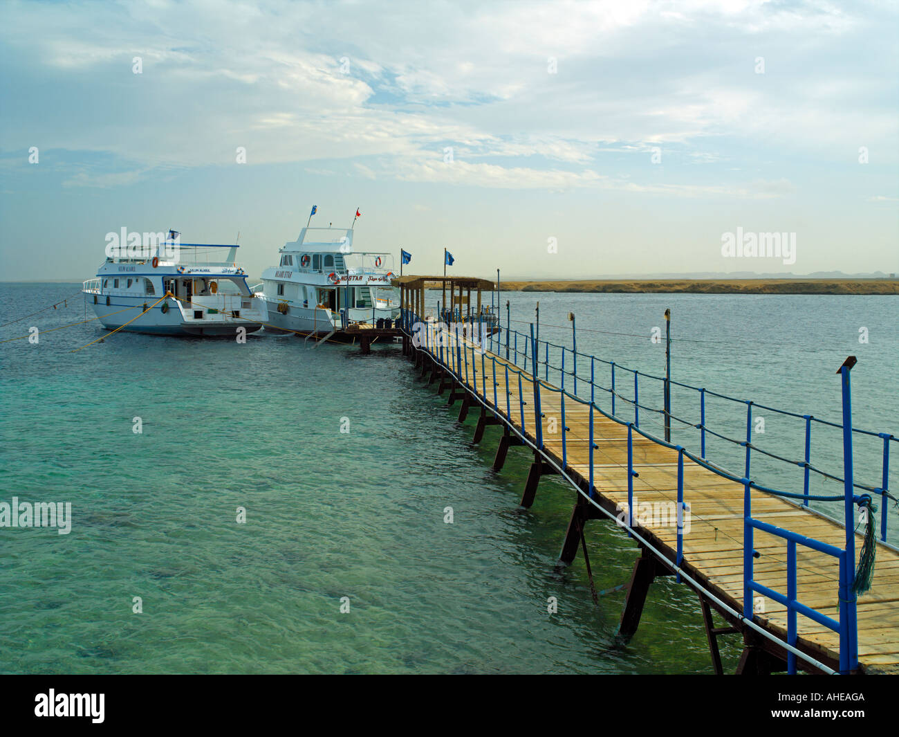 Dive boats tied to a jetty in Mangrove Bay on the Red Sea Stock Photo