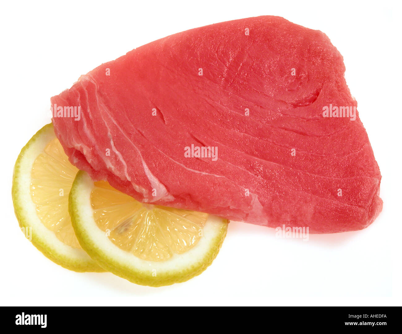 TUNA steak of Thunfisch tunafish fillets sushi quality lemon lime slices asia cooking Stock Photo