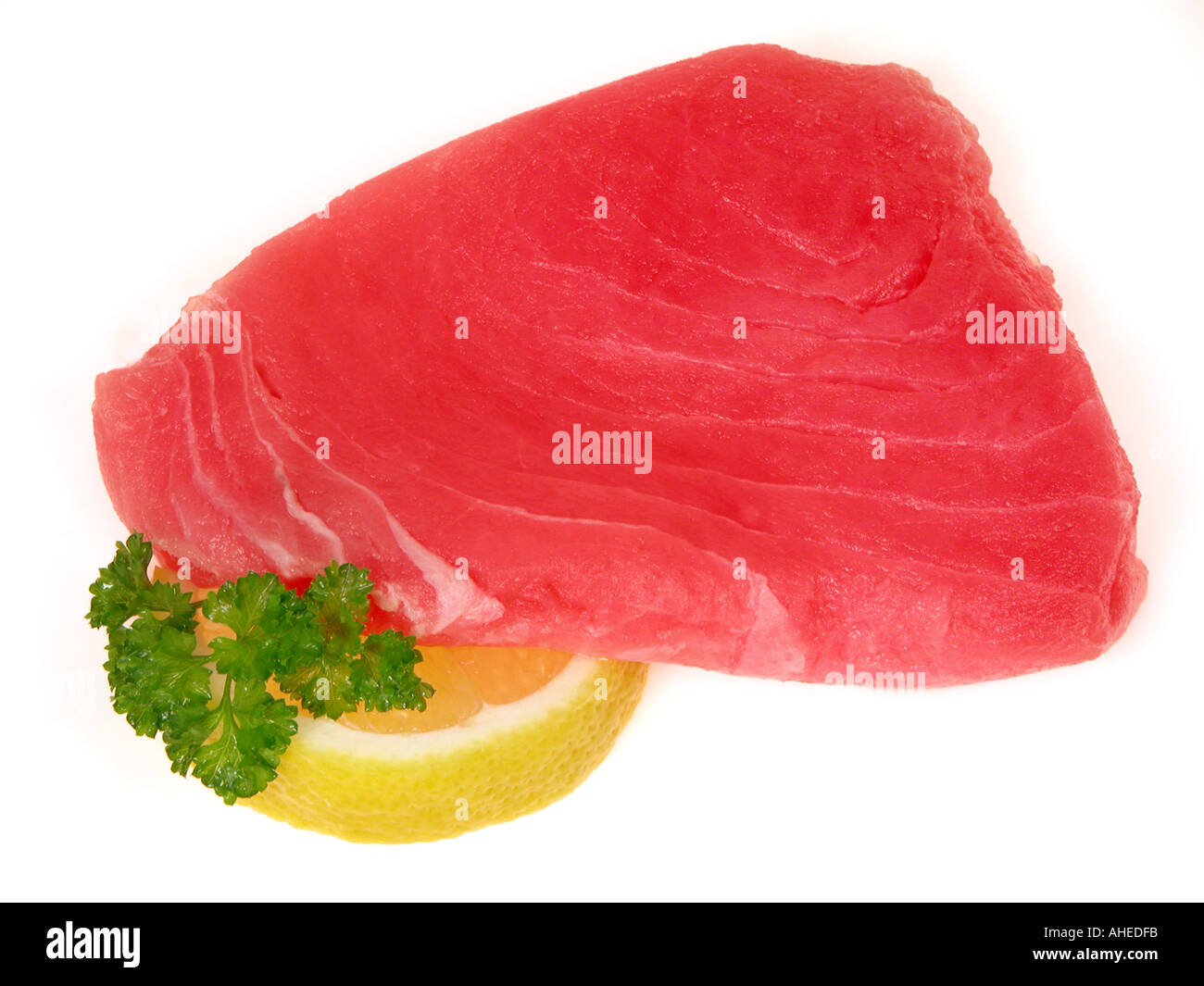 TUNA steak of Thunfisch tunafish fillets sushi quality lemon lime slices parsley Stock Photo