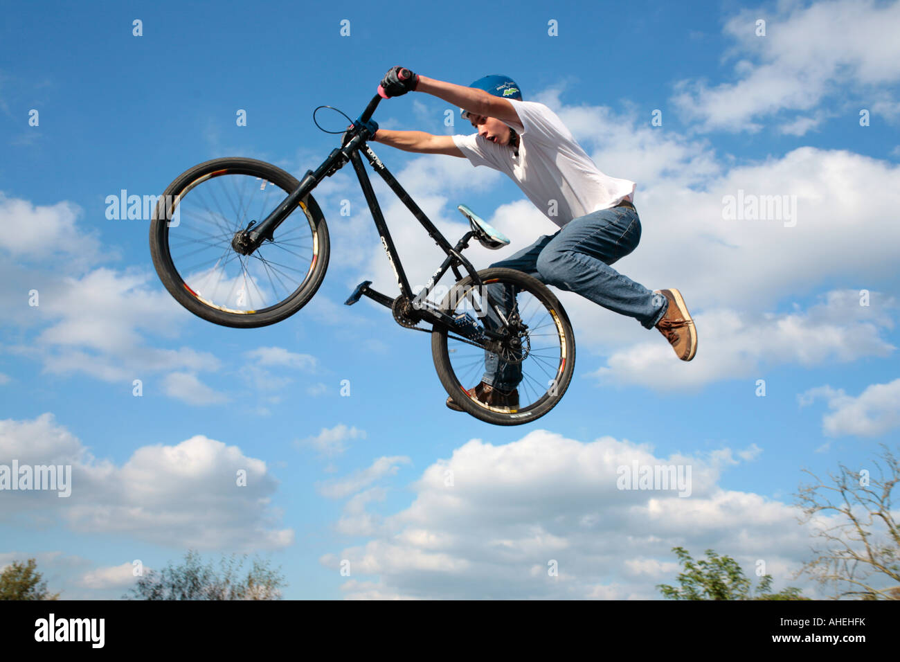 a teenage biker jumping with his bike Stock Photo Alamy