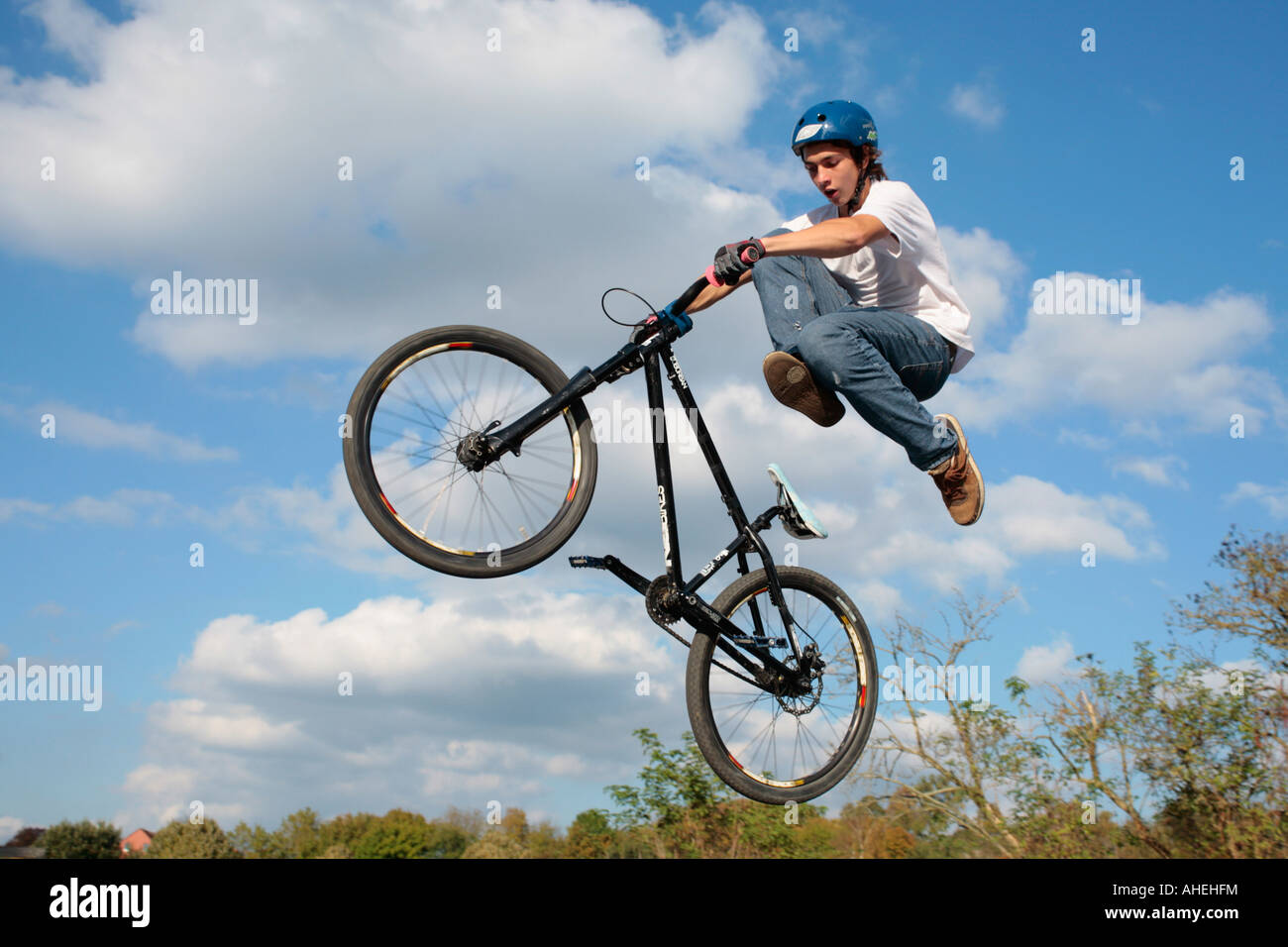 a teenage biker jumping with his bike Stock Photo Alamy