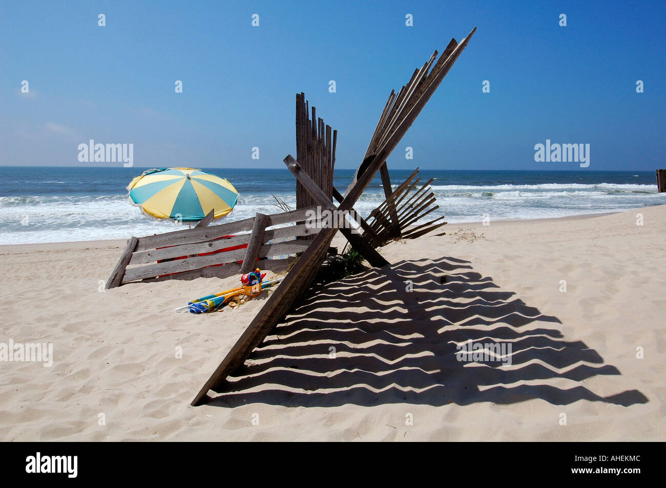 A wooden fence cast shadow on the sandy beach at Praia de Mira between Figueira da Foz and Aveiro.central Portugal Stock Photo