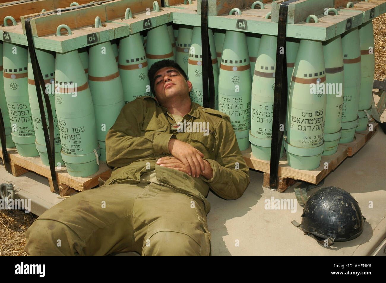 An Israeli soldier takes a nap after taking part in firing 155mm shells into Hezbollah positions from the Golan heights during Israeli-Hezbollah war Stock Photo