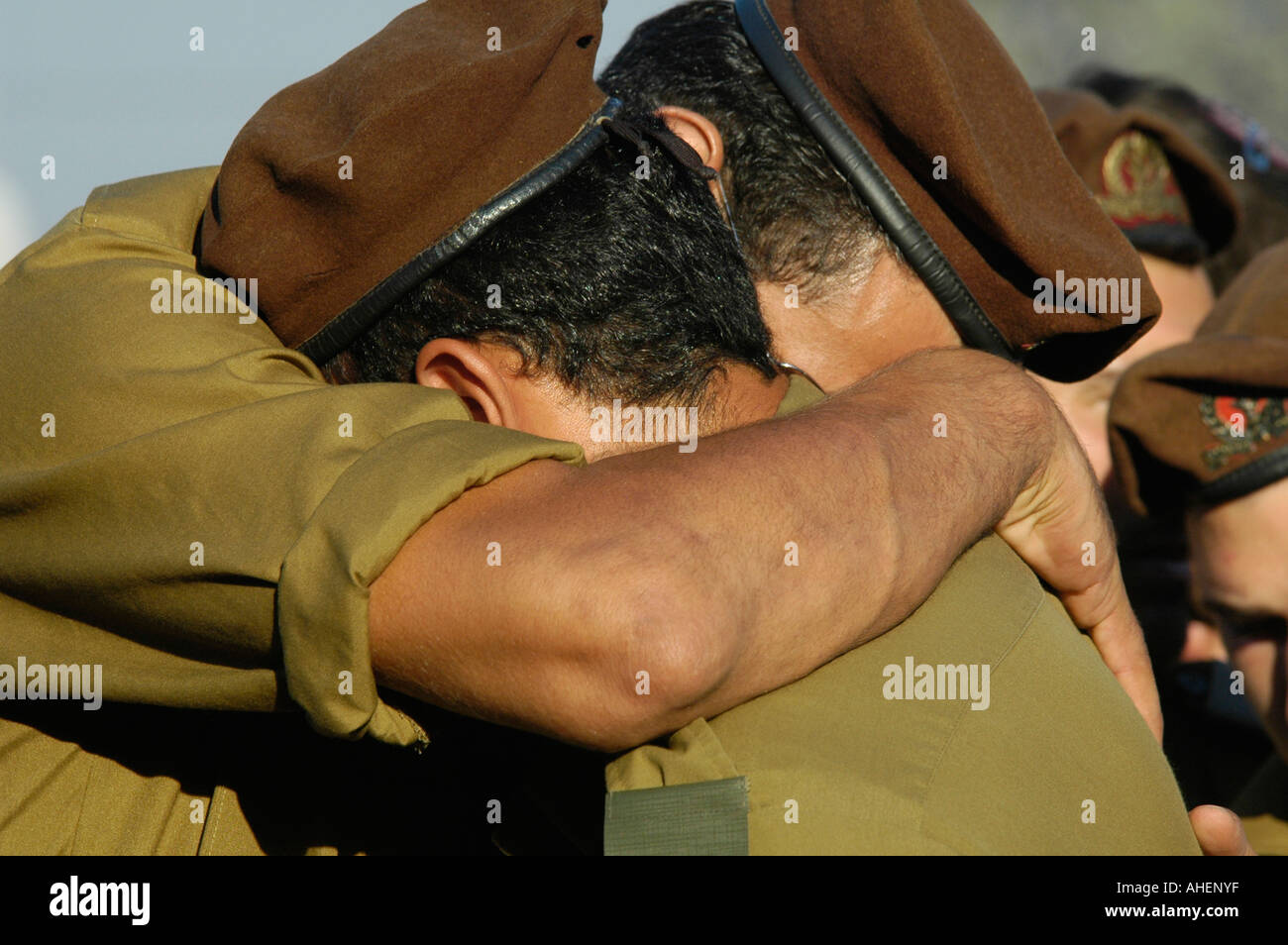 Israeli soldiers from the Golani brigade cling to each other before military funeral of a fallen soldier during the war with Hezbollah in Lebanon. Stock Photo