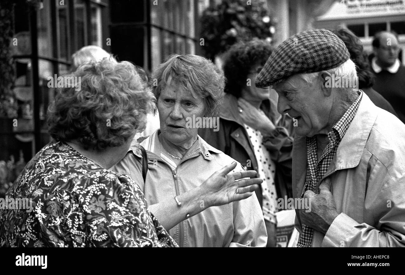 Group of older people having a serious discussion in the street Stock Photo