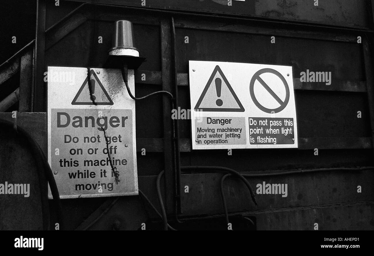 Danger signs on large industrial machine warning of movement and water jetting Stock Photo