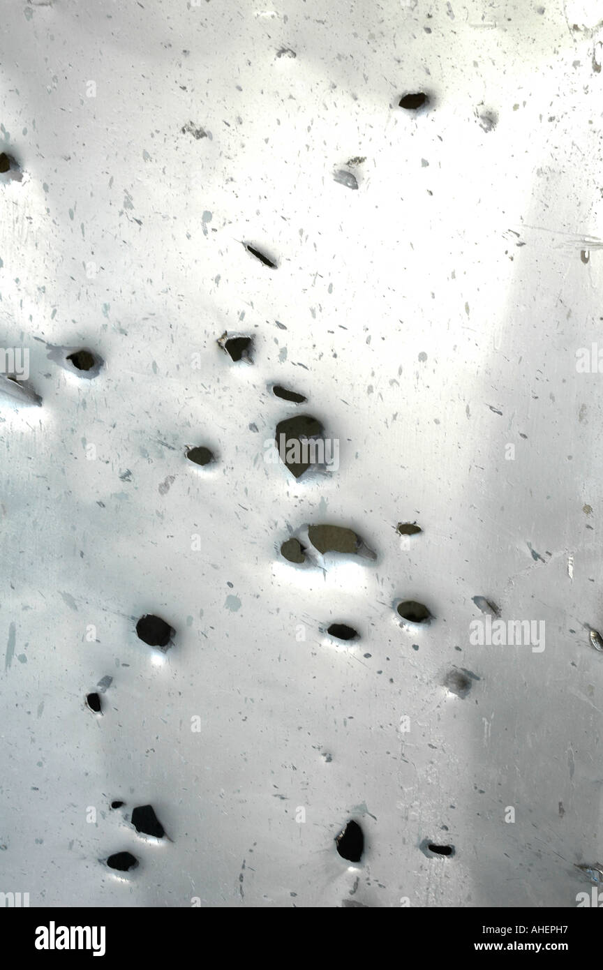 Metal doorway shows severe damage after it was hit by Katyusha rocket, Israel. Stock Photo