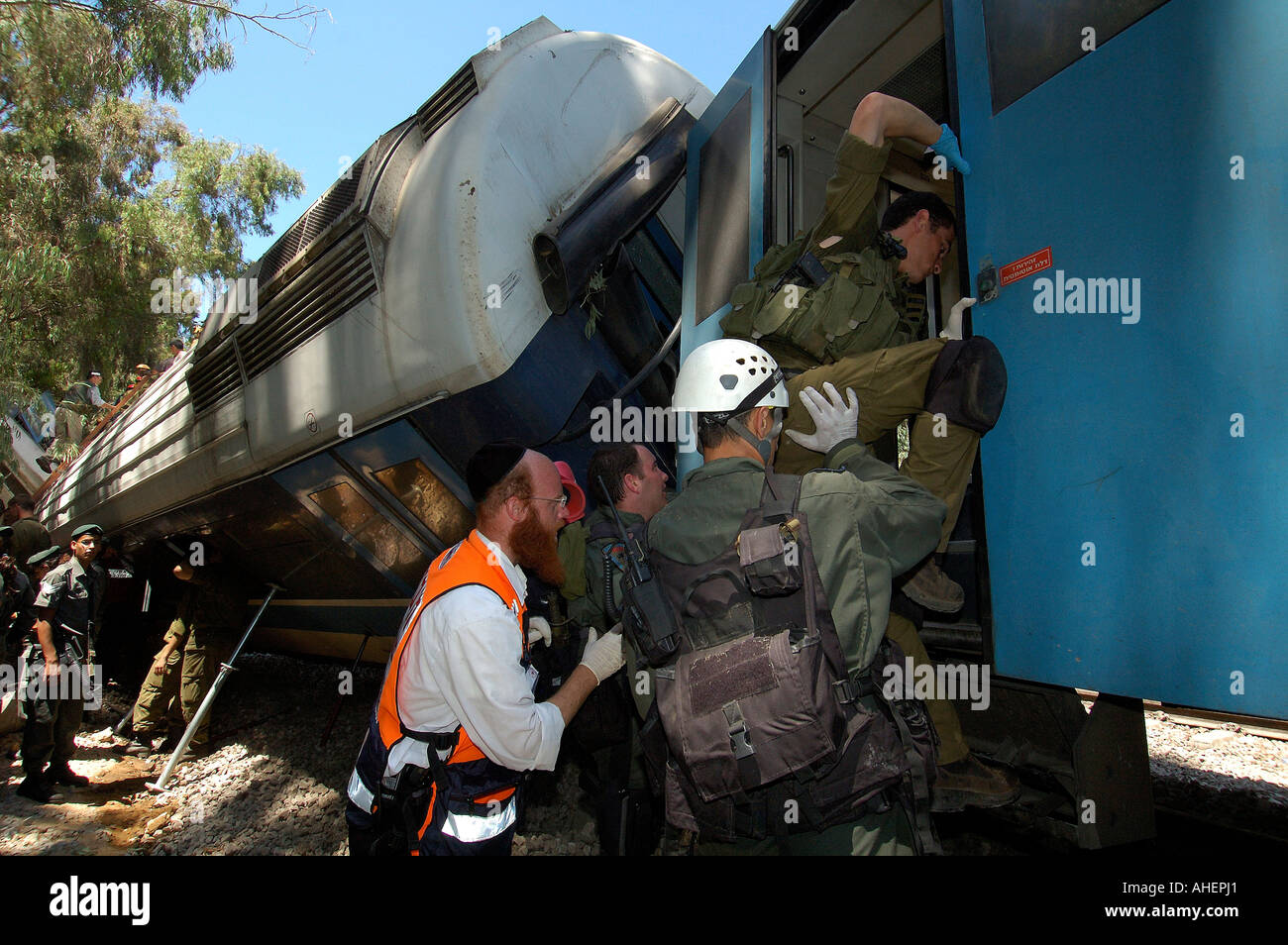 Israeli rescue forces enter an overturned wagon at a train crash site near Moshav Kfar Yehoshua in central Israel. Stock Photo