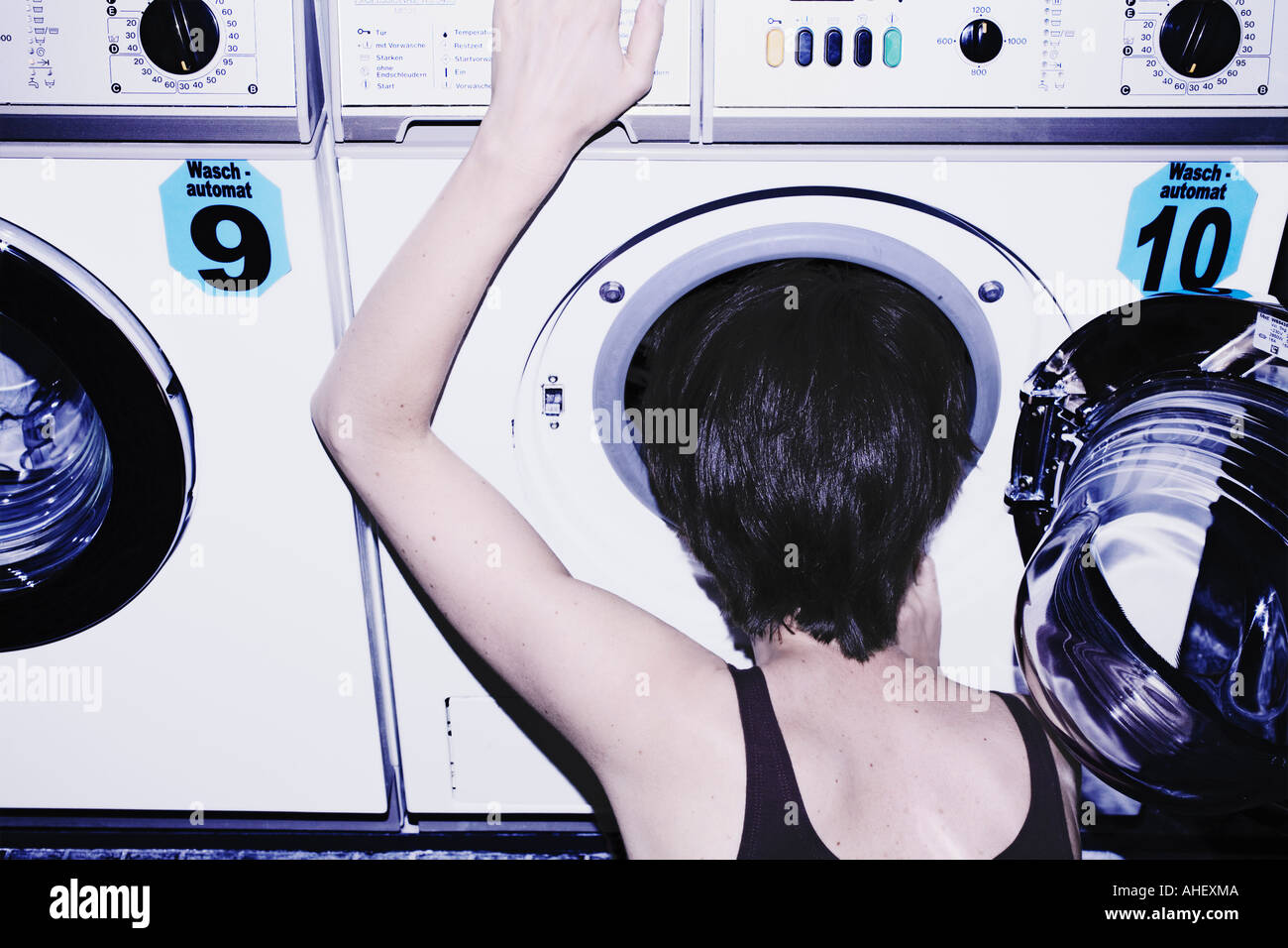 Young Woman Looking Into Laundromat Germany Stock Photo Alamy