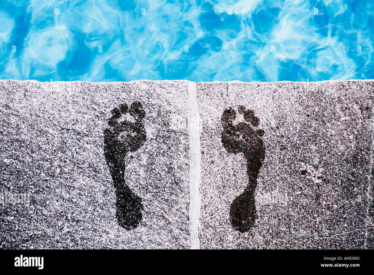 Footprints At Edge Of Swimming Pool Stock Photo