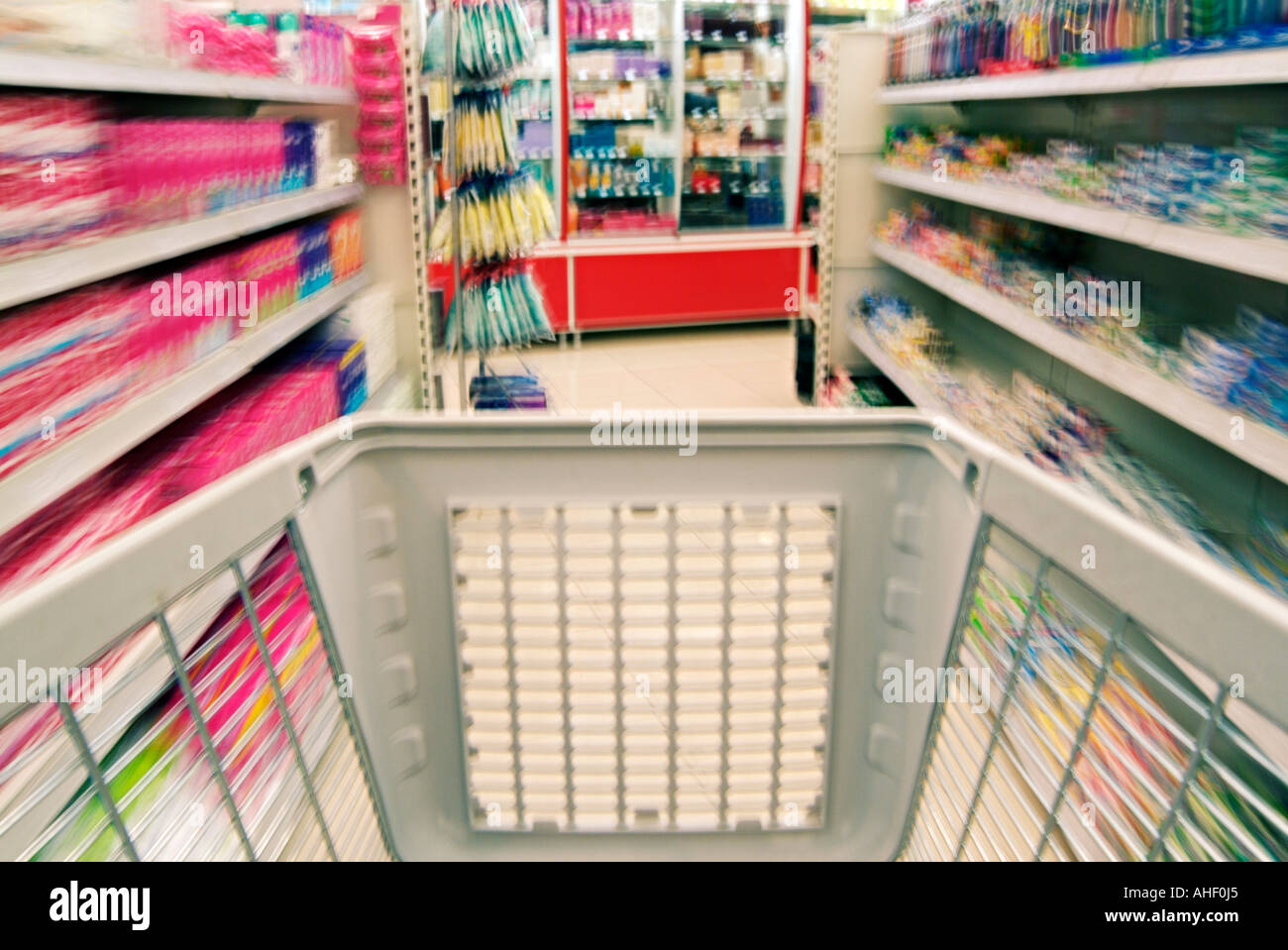 Shopping Trolley Rushing Through a Supermarket Aisle Stock Photo