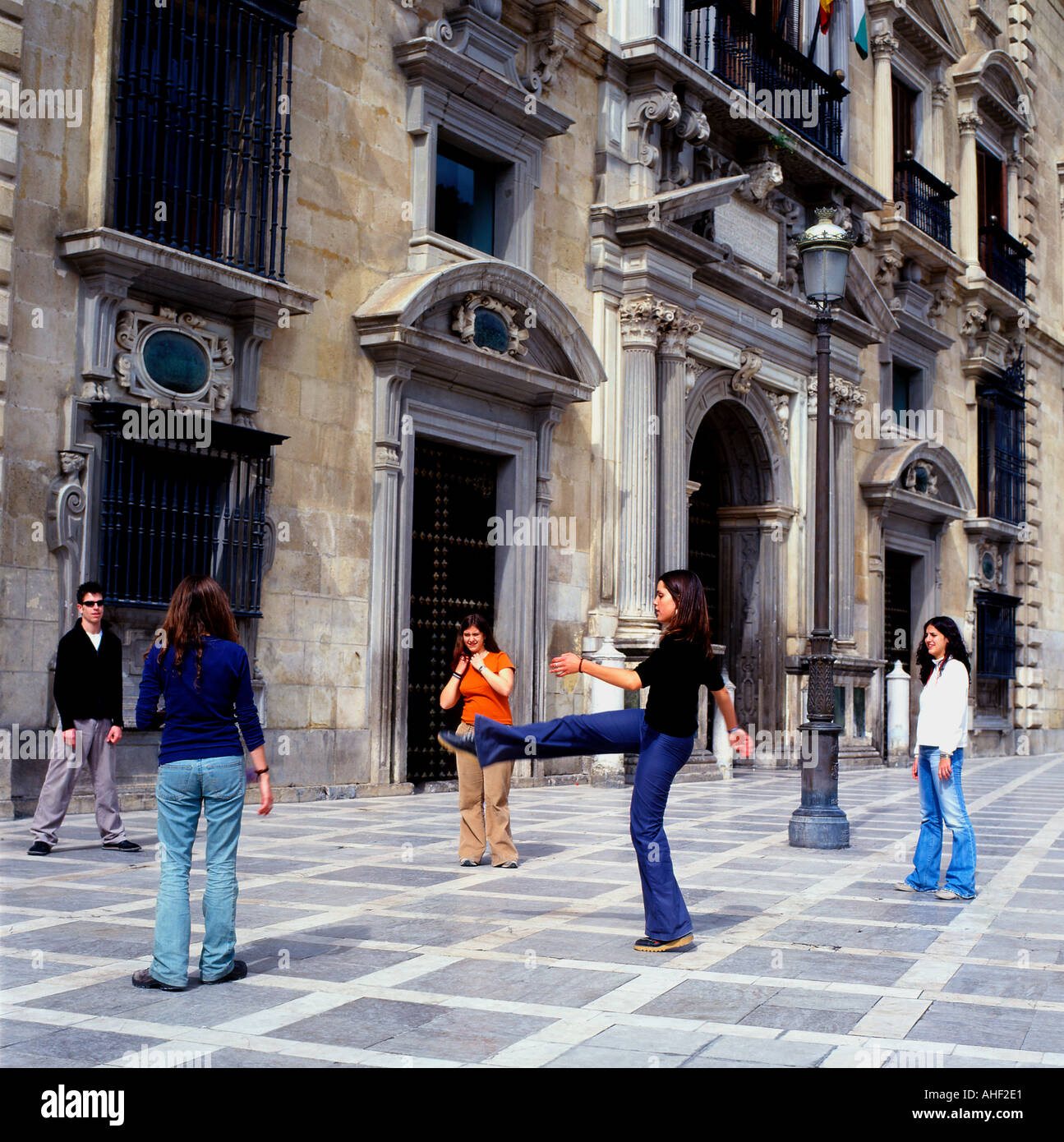 Young women playing a ball game in a street outside in Granada Andalusia Southern Spain Europe EU   KATHY DEWITT Stock Photo