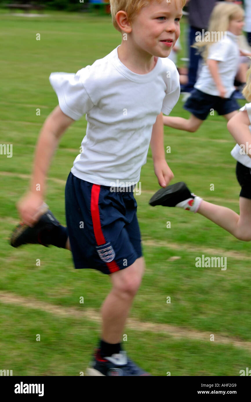 five year old boy running in a school sports day race Stock Photo