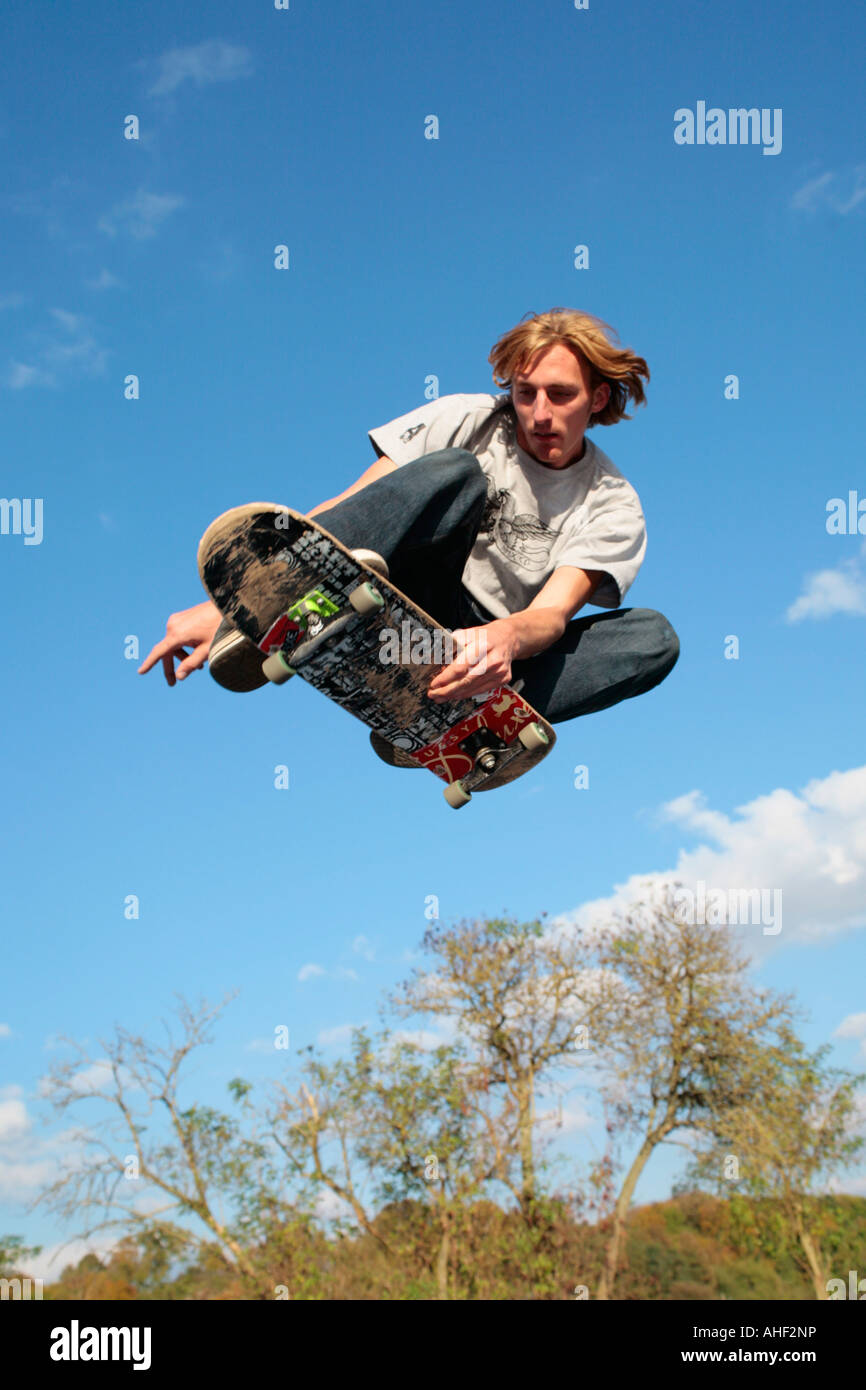 a young man jumping with his skateboard Stock Photo