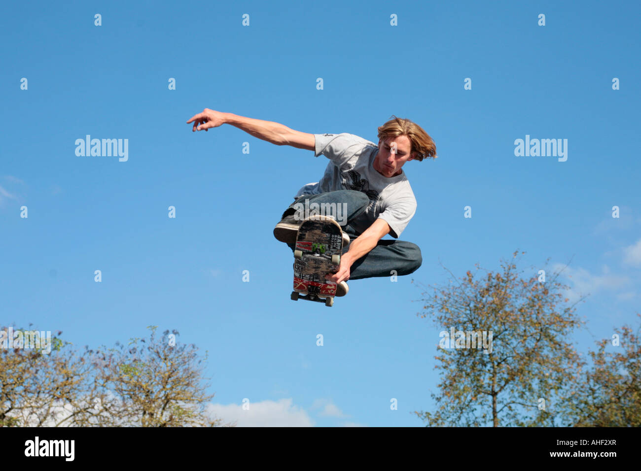 a young man jumping with his skateboard Stock Photo
