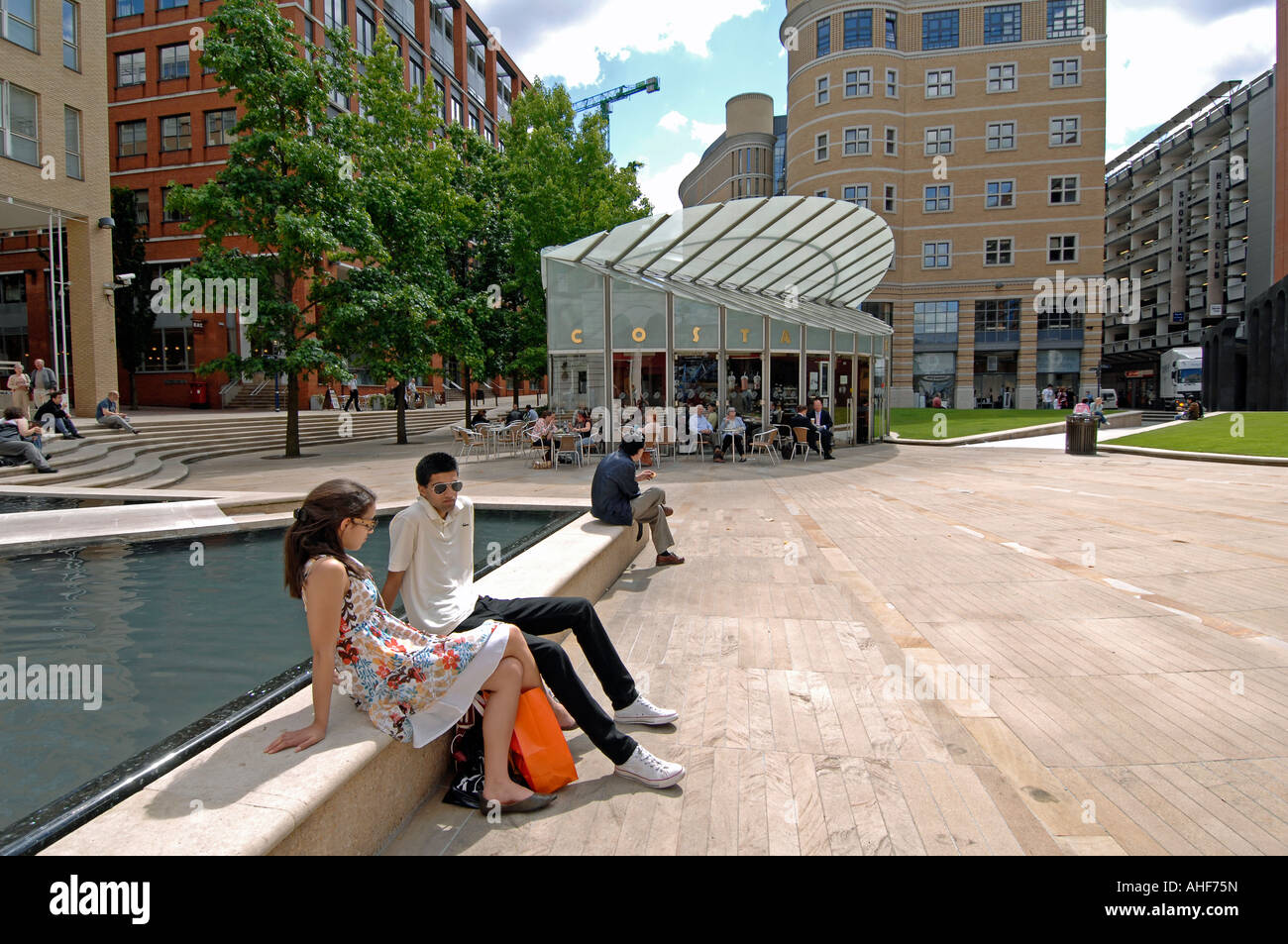 People relaxing by the water features in Brindley Place, Birmingham