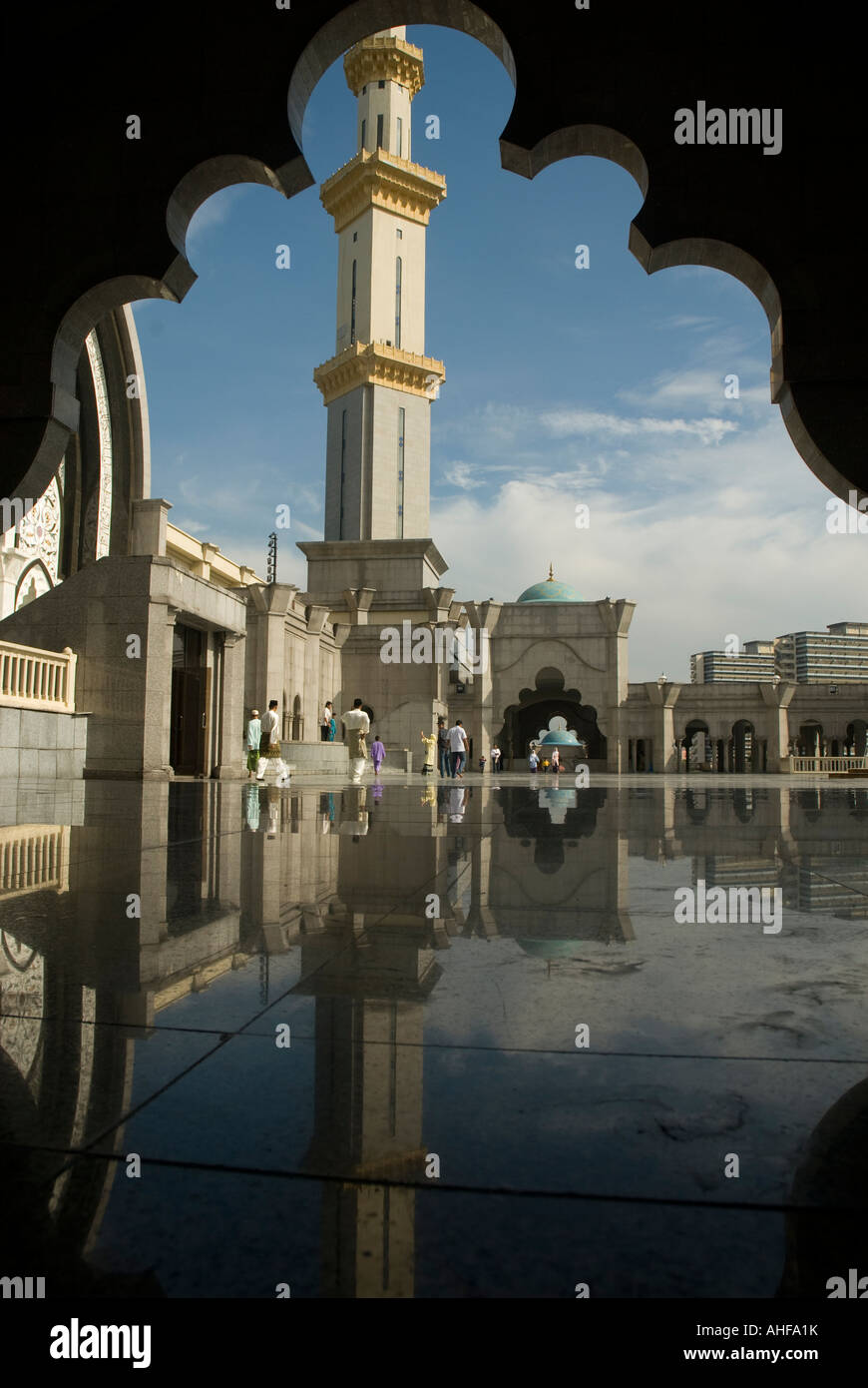 Reflections of moslems getting ready for prayer in of the mosques in Kuala Lumpur, Malaysia. Stock Photo