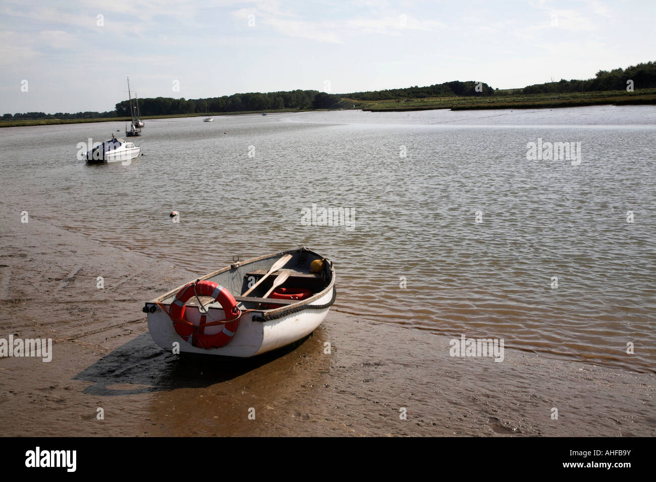Small dingy boat in mud Butley Creek, Suffolk, England Stock Photo Alamy