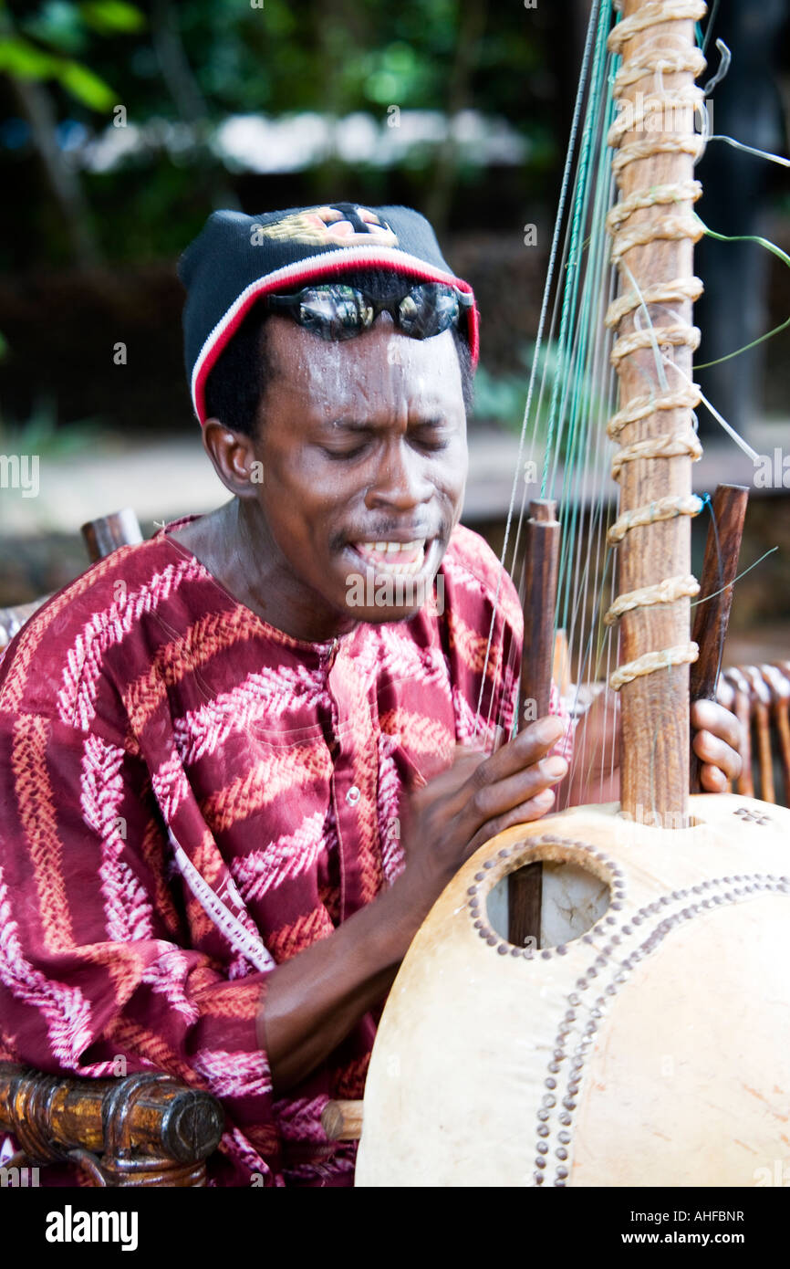 Gambian musician playing the Kora a traditional musical instrument taken at Makasutu nature reserve in The Gambia, West Africa Stock Photo