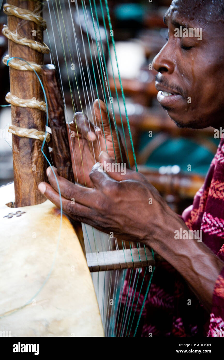 Close-up of Gambian musician playing the Kora a traditional musical instrument showing the hands in movement taken in The Gambia Stock Photo