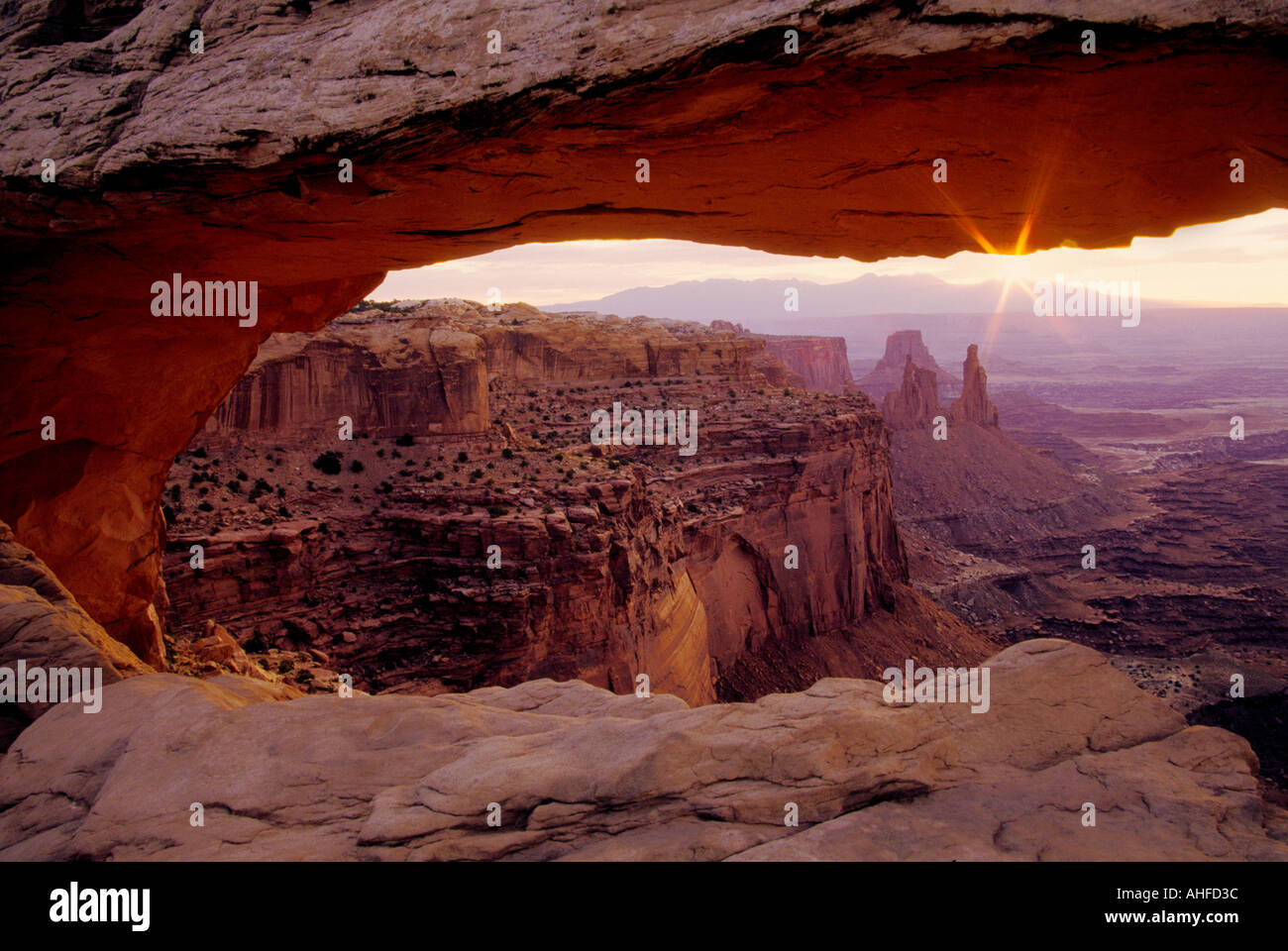 First light creates a starburst at Mesa Arch on Canyonlands National