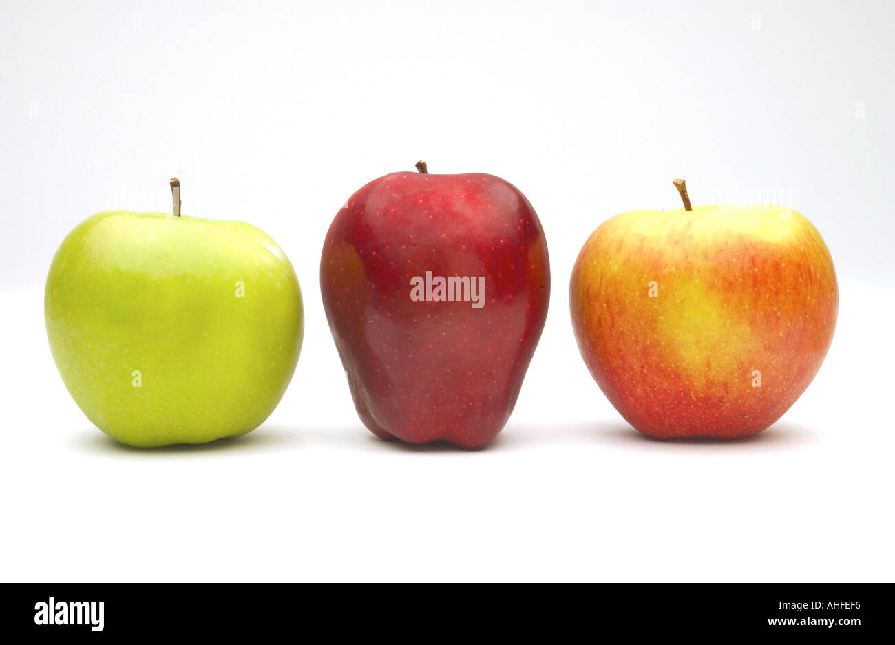 Horizontal color image of three apples that are red green and mixed on ...