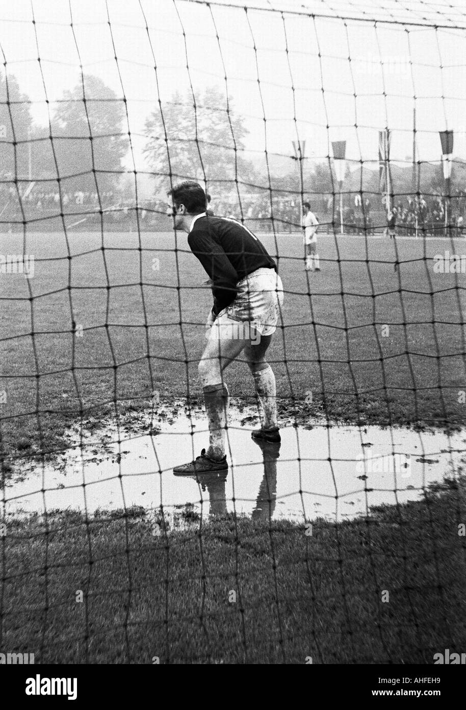football, international junior class tournament 1965, Roter Stern Belgrade versus VfL Bochum 4:2, Stadium an der Castroper Strasse in Bochum, scene of the match, keeper of Bochum stands in a puddle of water Stock Photo