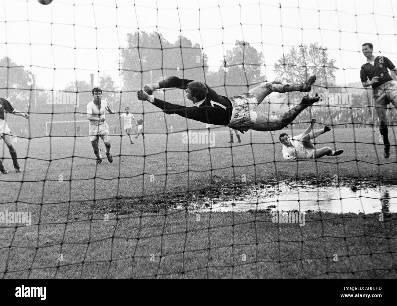 football, international junior class tournament 1965, Roter Stern Belgrade versus VfL Bochum 4:2, Stadium an der Castroper Strasse in Bochum, scene of the match, save by the keeper, puddle of water in the goal box Stock Photo