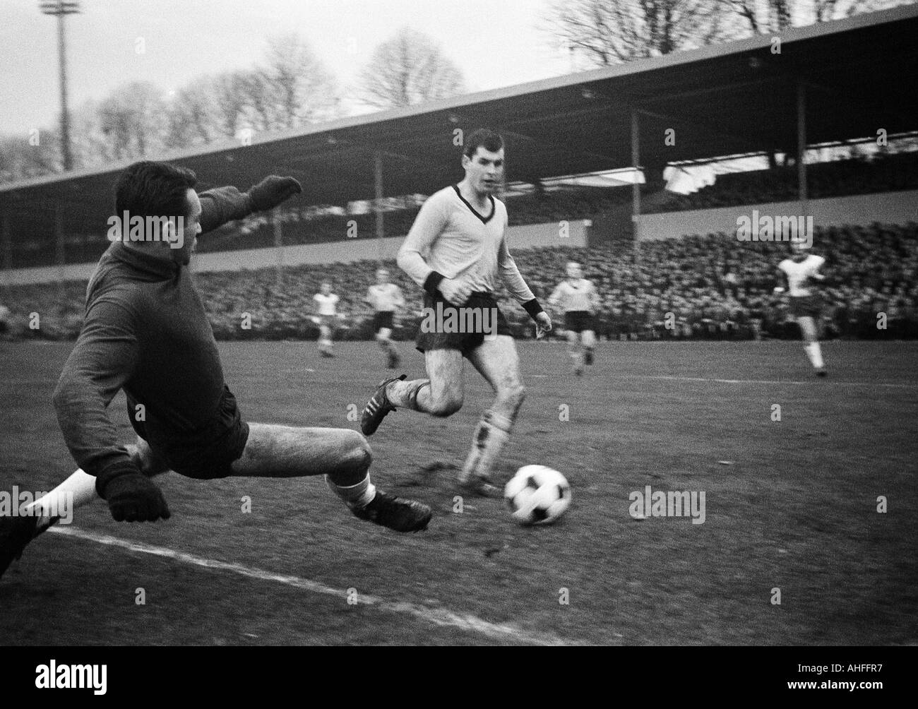 football, Bundesliga, 1965/1966, Stadium Rote Erde in Dortmund, Borussia Dortmund versus SV Werder Bremen 2:1, scene of the match, keeper Guenter Bernhard Bremen, left) and Lothar Emmerich (BVB) Stock Photo