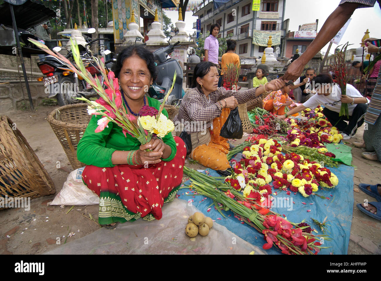 Friendly flower vendor with a bouquet at market Kathmandu Nepal Stock