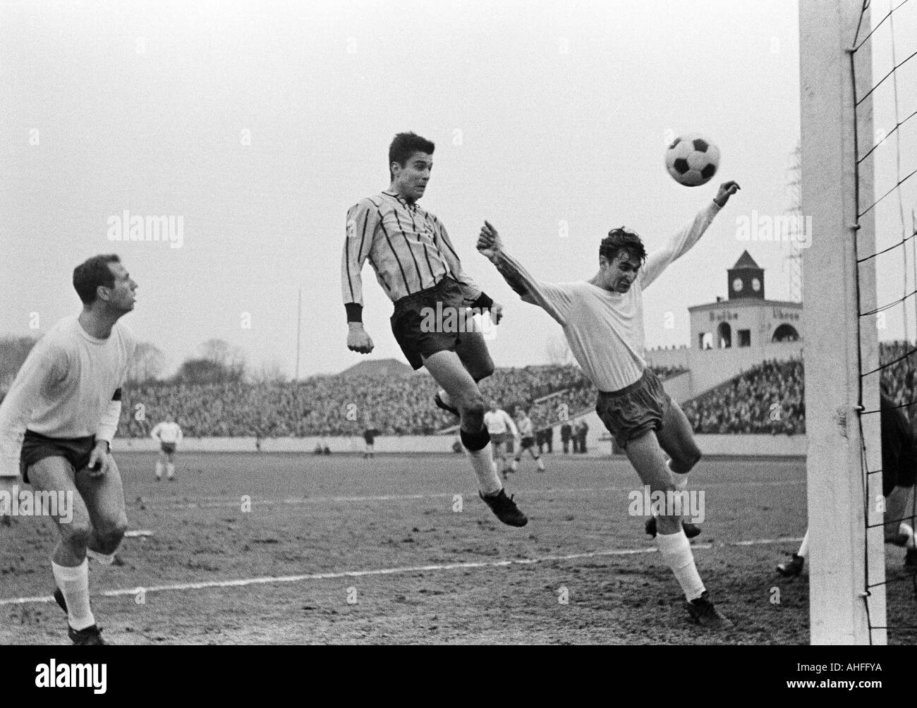 football, Regionalliga West, 1965/1966, Niederrhein Stadium in Oberhausen, Rot-Weiss Oberhausen versus Alemannia Aix-La-Chapelle 2:3, scene of the match, 0:2 header goal, f.l.t.r. Friedhelm Kobluhn (RWO), goal scorer Karl Heinz Sell (Aachen), Dieter Hents Stock Photo