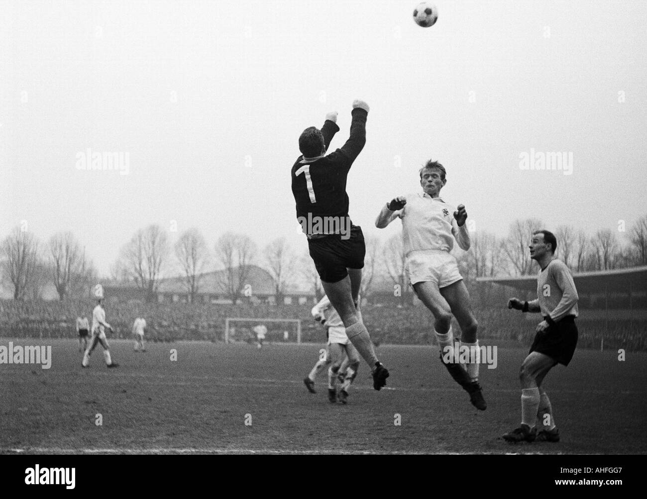 football, Bundesliga, 1965/1966, Borussia Dortmund versus Borussia Moenchengladbach 3:1, Stadium Rote Erde, scene of the match, punched clearance by keeper Hans Tilkowski (BVB) before Rudolf Poeggeler (MG), right Wilhelm Sturm (BVB) Stock Photo